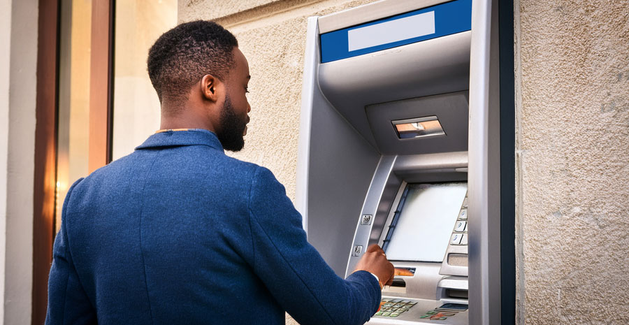 Person using an ATM at a bank